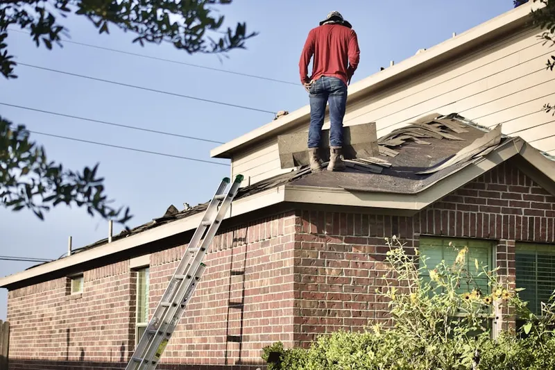 Professional roofer working on a residential roof in Fox Island